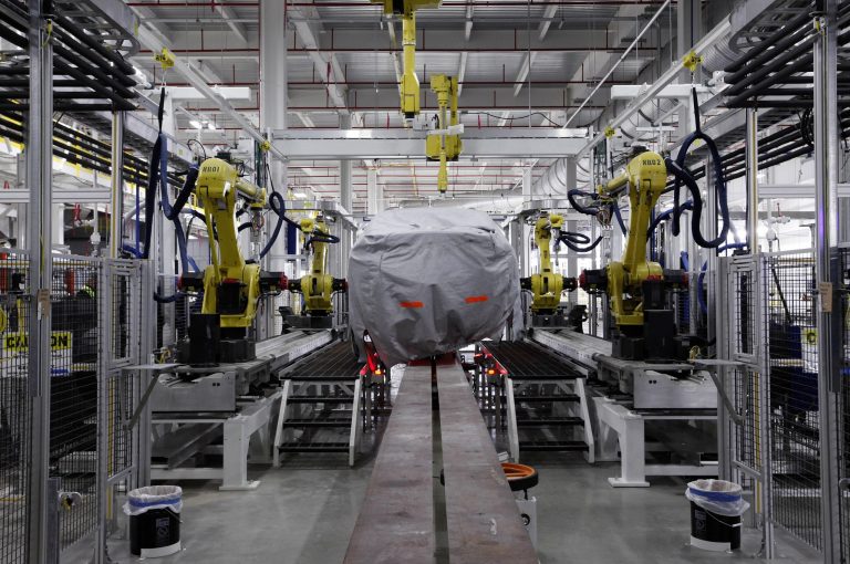 FILE - In this Tuesday, July 16, 2013, file photo, a covered vehicle sits in part of the new paint shop at Chrysler's Sterling Heights Assembly Plant in Sterling Heights, Mich. The Commerce Department issues its first estimate of how fast the U.S. economy grew in the July-September quarter on Thursday, Nov. 7, 2013. (AP Photo/Paul Sancya, File)