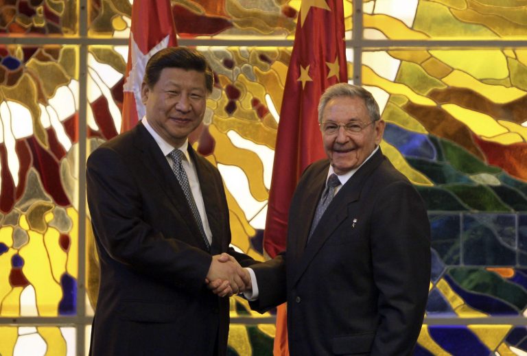 Cuba's President Raul Castro, right, shakes hands with China's President Xi Jinping during a meeting at Revolution Palace in Havana, Cuba, Tuesday, July 22, 2014. Xi Jinping is in an official state visit to Cuba. (AP Photo/Cubadebate, Ismael Francisco)