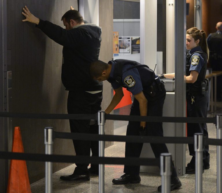 Security officials check a man at a courthouse in Montreal on Tuesday, April 23, 2013. Reed Jaser, one of two men accused of plotting a terrorist attack against a Canadian passenger train with support from al-Qaida elements in Iran, made a brief court appearance Tuesday but did not enter a plea. Canadian investigators say Jaser, 35, and his suspected accomplice Chiheb Esseghaier, 30, received 