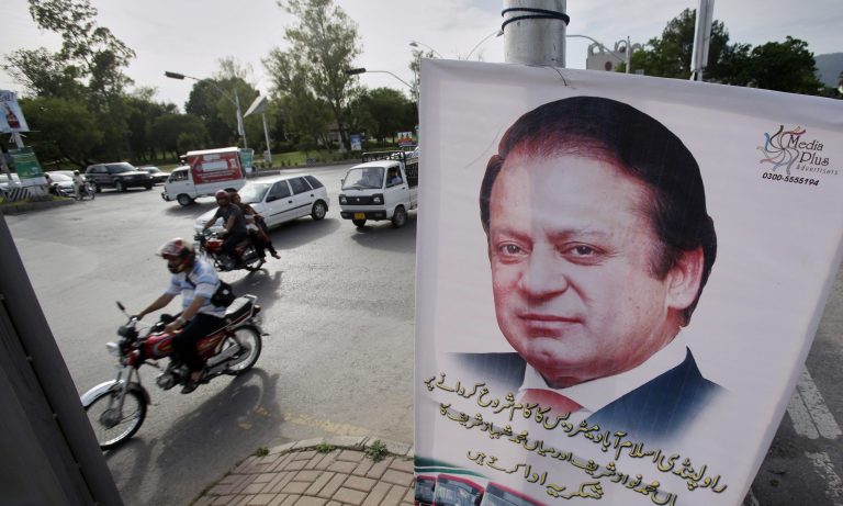 Motorists ride past a banner of Pakistani Prime Minister Nawaz Sharif hanging on an electricity pole in Islamabad, Pakistan. Sharif will attend the inauguration of India's Prime Minister-designate Narendra Modi, a first for the nuclear-armed rivals, officials said Saturday. Pakistan and India have a history of uneasy relations and they have fought three wars over the disputed Himalayan region of Kashmir since their independence from Britain in 1947. Saturday's decision by Sharif could signal a further easing of tensions. (AP Photo/Anjum Naveed)