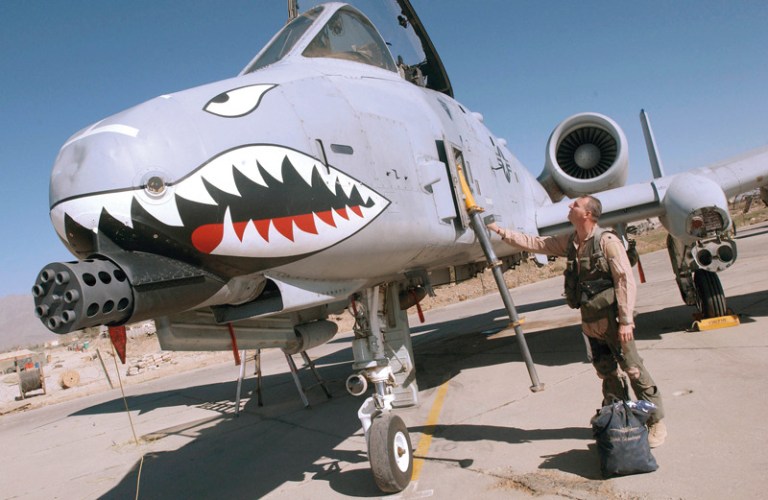 Tim, a Lt. Colonel in the U.S. Air Force, checks the exterior of his A-10 Thunderbolt II attack aircraft, known as the 