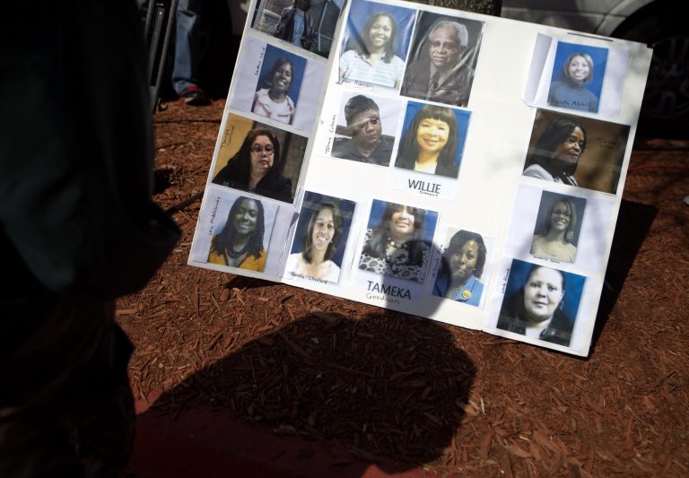 Photos of some of the 35 defendants in Atlanta's school cheating scandal decorate a board as the media wait for the defendants to turn themselves in at Fulton County Jail, Tuesday, April 2, 2013, in Atlanta. The defendants are named in a 65-count indictment that alleges a broad conspiracy involving cheating on standardized tests in Atlanta Public Schools. All 35 defendants must turn themselves in Tuesday. (AP Photo/David Goldman)