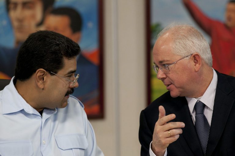 FILE - In this Nov. 15, 2013, file photo, Venezuela's President Nicolas Maduro, left, speaks with his Oil Minister Rafael Ramirez before the start of a press conference at Miraflores presidential palace in Caracas, Venezuela. President Maduro has replaced on Tuesday Sept. 2, 2014, Venezuela's longtime oil minister and economic czar as part of a cabinet shakeup sidelining the most-prominent voice within his administration for much-needed reforms to address the country's economic crisis.  (AP Photo/Ariana Cubillos, File)