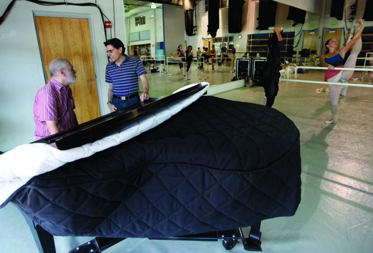 In this photo taken Tuesday, July 31, 2012, Francisco Renno, left, talks with Edward Villella, founding artistic director of the Miami City Ballet, during a company class in Miami Beach, Fla. Villella, who built the Miami City Ballet into an internationally recognized company, has left sooner than expected, the company announced Tuesday, Sept. 4, 2012. Villella, 75, said last year he would retire after the 2012-2013 season ends in April. But ballet officials announced Tuesday that Villella has decided to leave now. (AP Photo/Lynne Sladky)