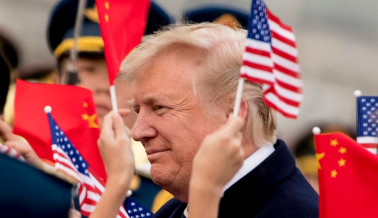 Children wave U.S. and Chinese flags as President Trump arrives at Beijing Airport, Wednesday, Nov. 8, 2017, in Beijing, China. Trump is on a five country trip through Asia traveling to Japan, South Korea, China, Vietnam and the Philippines. (AP Photo/Andrew Harnik)