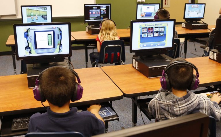 In this July 21, 2014 file photo, students at a summer reading academy at Buchanan elementary school work in the computer lab at the school in Oklahoma City. (AP Photo/Sue Ogrocki,File)