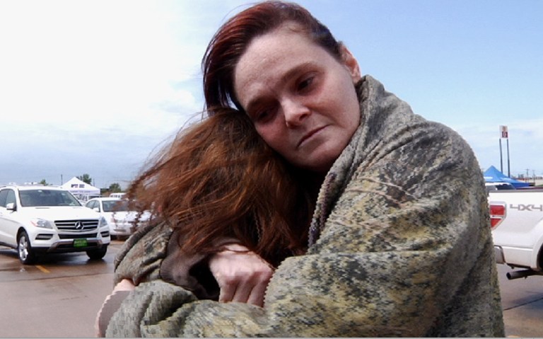 In this image made from video, Amy Sharp, right, hugs daughter Jenna Dunn, 10, a day after she picked up her children from Plaza Towers Elementary School in Moore, Okla., which was leveled by a tornado packing winds of up to 200 mph. on Tuesday, May 21, 2013, in Moore, Okla. (AP Photo/P. Solomon Banda)