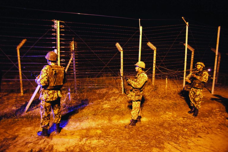 Indian Border Security Force (BSF) soldiers stand guard during a night patrol near international border fencing at Suchet Garh in Ranbir Singh Pura, about 27 kilometers (17 miles) south of Jammu, India, Thursday, Jan. 10, 2013. The Pakistani army accused Indian troops of firing across the disputed Kashmir border and killing a soldier Thursday, the third deadly incident in the disputed Himalayan region in recent days. (AP Photo/Channi Anand)