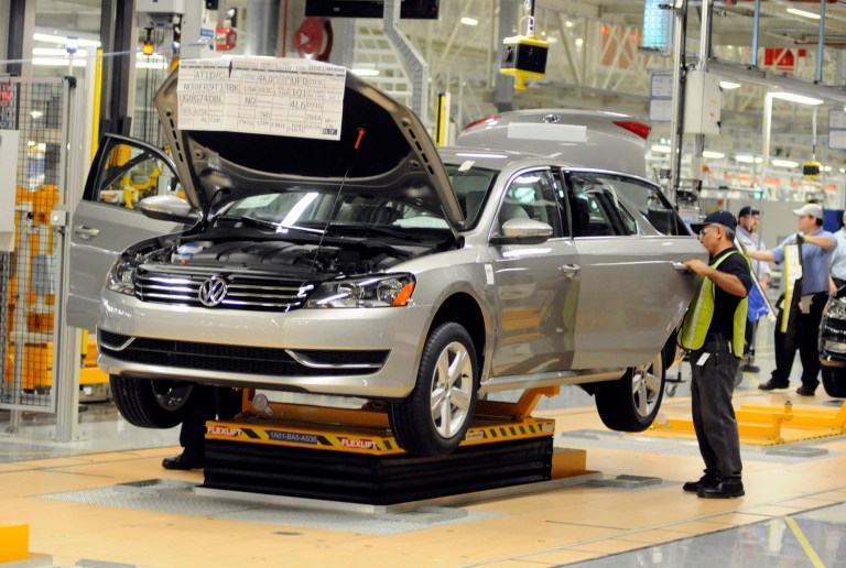 Workers inspect the doors of a new Passat inside the Volkswagen plant in Chattanooga Tenn., Wednesday. May 24,2011. (AP Photo/Billy Weeks)