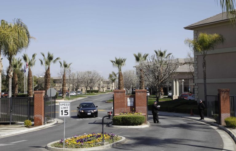 A car passes through the gate of Glenwood Gardens in Bakersfield, Calif., Monday March 4, 2013, where an elderly woman died after a nurse refused to perform CPR on her last week. The central California retirement home is defending one of its nurses who refused pleas by a 911 operator to perform CPR on an elderly woman, who later died. 
