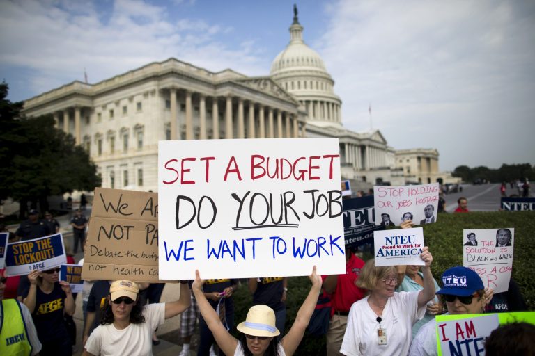 Protestors hold signs during a during an event with the Democratic Progressive Caucus and furloughed federal employees as the budget battle continues.President Obama on Friday sought to end the controversy over an administration official's remark that the White House was 