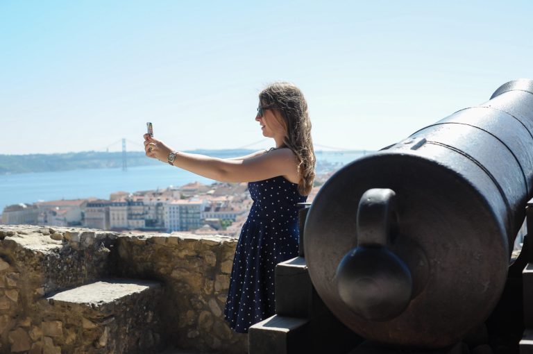 This June 2013 photo shows Abigail Austin taking a selfie on a trip to Lisbon, Portugal, when she was 17. Young travelers say they enjoy taking selfies to preserve and curate travel memories while sharing experiences with friends. But some older travelers worry that spending too much time on social media can be a distraction from enjoying and learning about a place. (AP Photo/Susan Austin Photography)