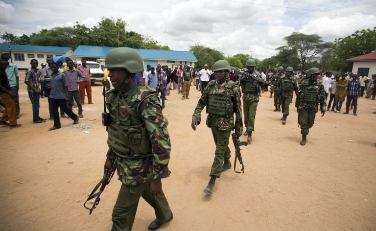 Kenya Defence Forces (KDF) soldiers arrive at a hospital to escort the bodies of the attackers to be put on public view, in Garissa, Kenya Saturday, April 4, 2015. Authorities displayed the bodies of the alleged attackers involved in the killings at Garissa University College on the bed of a pickup truck that drove slowly past the crowd gathered in a large open area. (AP Photo/Ben Curtis)