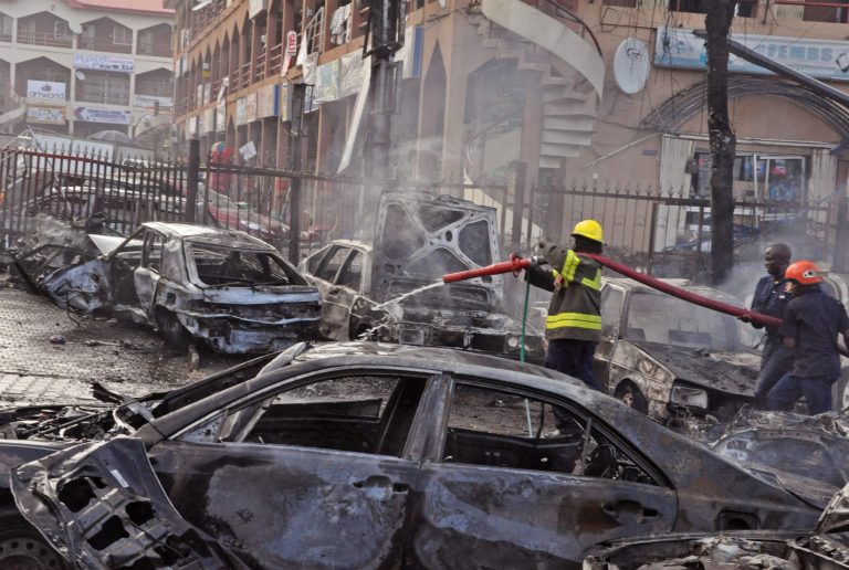 Rescue services work at the scene of an explosion at a shopping mall in Abuja, Nigeria, Wednesday, June 25, 2014. An explosion rocked a shopping mall in Nigeria's capital, Abuja, on Wednesday and police say at least over 20 people have been killed and many wounded. Witnesses say body parts were scattered around the exit to Emab Plaza, in the upscale Wuse 11 suburb. (AP Photo/Olamikan Gbemiga)