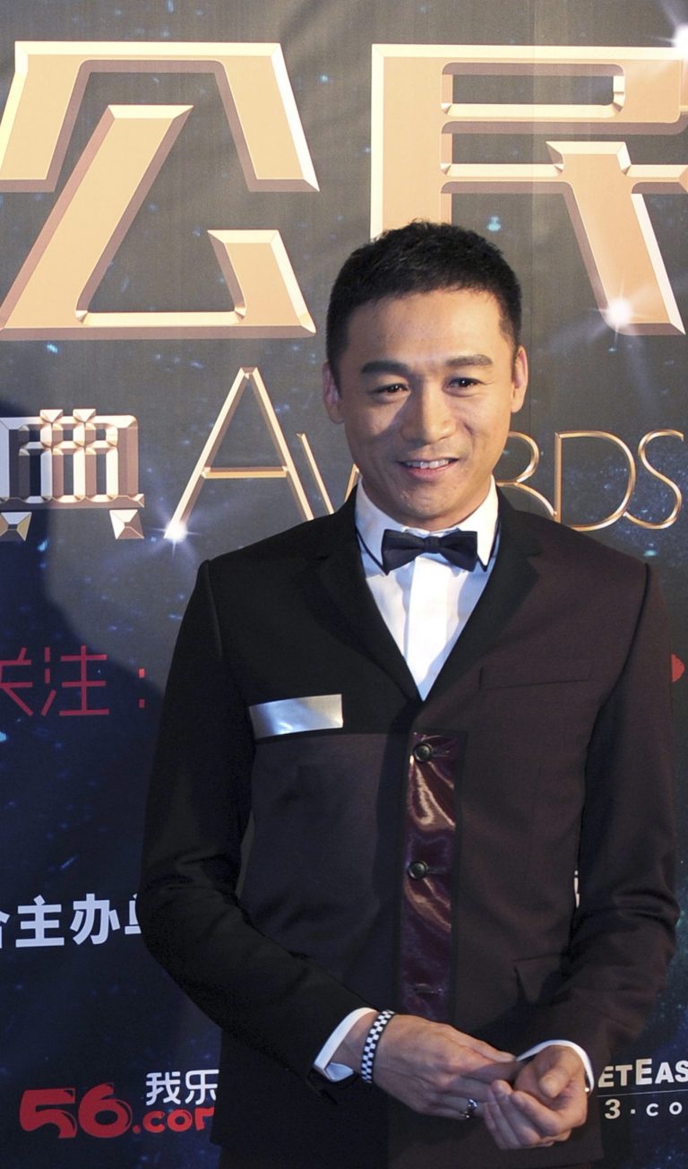 In this photo taken Tuesday, March 18, 2014, actor Gao Hu poses on the red carpet during the award ceremony of the Celebrity Citizens in Beijing, China. Gao, 40, who had a small part as a soldier in Zhang Yimou's 2011 movie 