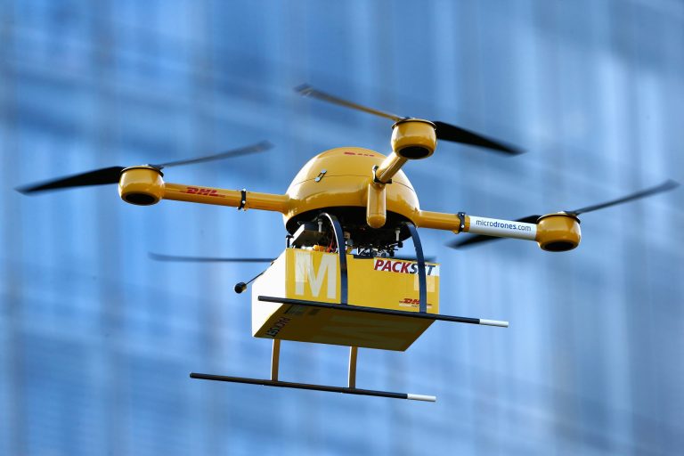 A quadcopter drone arrives with a small delivery at Deutsche Post headquarters on December 9, 2013 in Bonn, Germany. Red tape and lack of regulation regarding drone deliveries has given European retailers an edge over U.S. companies. (Photo by Andreas Rentz/Getty Images)