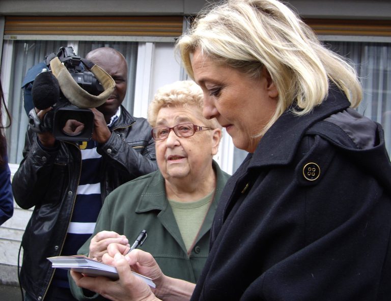   In this photo dated Wednesday, June 6, 2012, French far-right leader, Marine Le Pen, left, takes notes while listening to Telkla Plucinski as she campaigns at a market ahead of Sunday's first round legislative elections in Evin Malmaison, northern France. France's far right leader Marine Le Pen is running for a parliament seat against far left leader Jean-Luc Melenchon in a depressed northern district that illustrates why voters around troubled Europe are attracted to the political extremes. (AP Photo/Elaine Ganley)  