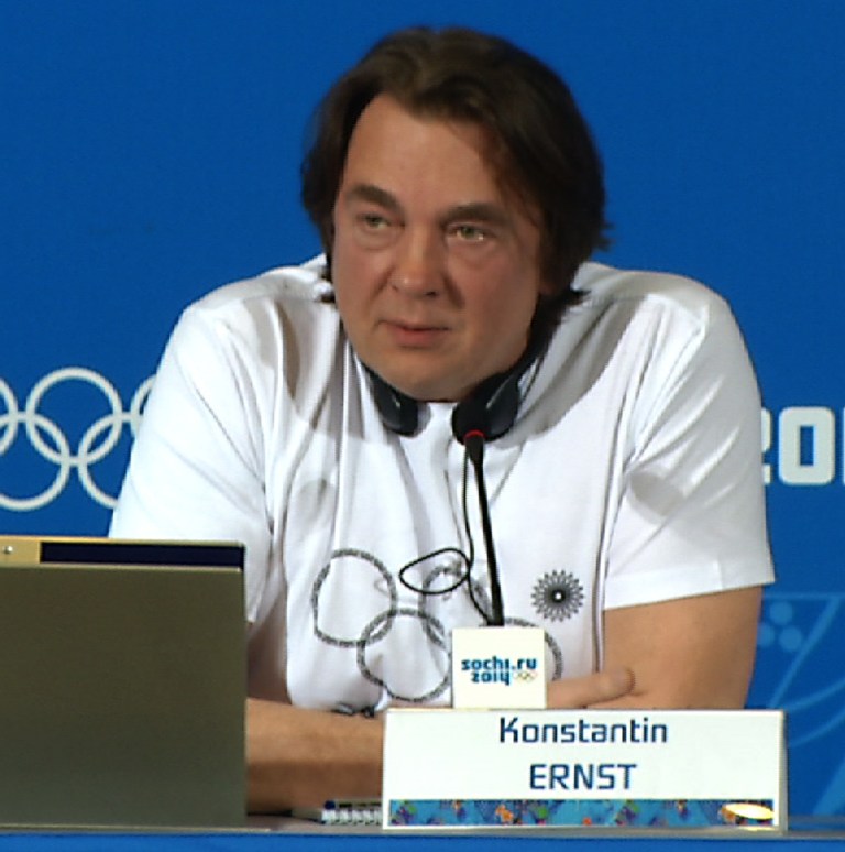 Konstantin Ernst, chief creative director of the opening and closing ceremonies for the 2014 Winter Olympics in Sochi, wears a T-shirt with the Olympic rings where one of the five rings is a snowflake during a news conference on the last day of the Olympics in Sochi, Russia, Sunday, Feb. 23, 2014. The T-shirt is a reference to the opening ceremony, when five snowflakes were supposed to open up into the five Olympic rings, but one failed to open. Ernst was met with applause and laughter when he took off his jumper at the press conference, revealing the T-shirt with the glitch. (AP Photo/Dorothee Thiesing)