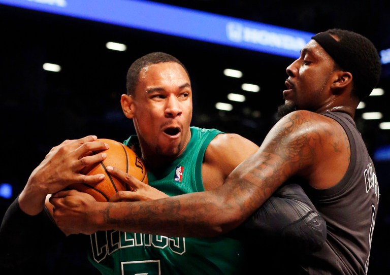   Boston Celtics forward Jared Sullinger (7) and Brooklyn Nets forward-center Andray Blatche (0) battle for the ball in the first half of their NBA basketball game at the Barclays Center, Tuesday, Dec. 25, 2012, in New York. (AP Photo/John Minchillo)  
