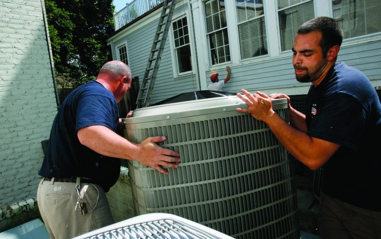 FILE- In this Monday June 9, 2008, file photo, Charles Brinkley, left, and John Lerro, with Great American Heating and Air Conditioning, Inc., install an air conditioner in Chevy Chase, Md. A sharp decline in the price of natural gas makes it much cheaper for U.S. utilities to produce electricity. It just isn't having any impact on homeowners' monthly bills. Instead of falling, electricity prices aren't budging. They are rising just as families begin cranking up their air conditioners. (AP Photo/Jacquelyn Martin, File)
