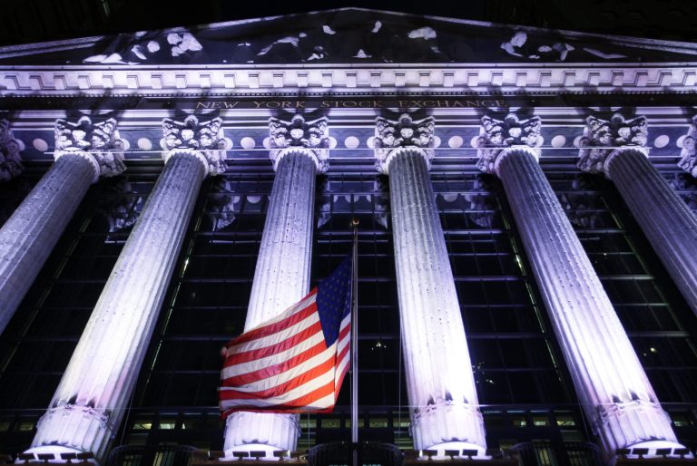 An American flag flies in front of the New York Stock Exchange, Wednesday, Oct. 8, 2014 in New York. Stocks are moving between gains and losses in early trading as traders digest the latest corporate earnings news. Later Wednesday the Federal Reserve releases minutes from its latest policy meeting last month. (AP Photo/Mark Lennihan)