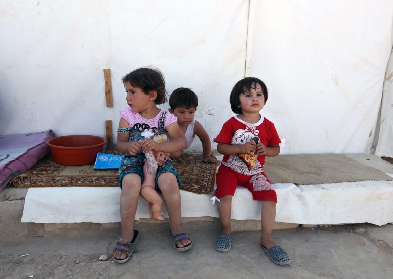 Syrian refugees children sit outside their tent at a Syrian refugee camp in the eastern town of Marj in Bekaa valley, Lebanon, Sunday, June 29, 2014. Across a wide belt that stretches halfway around the globe, the world's estimated 1.6 billion Muslims mark the beginning of Ramadan this weekend. The holy season is marred by unprecedented turmoil, violence and sectarian hatreds that threaten to rip apart the Middle East, the epicenter of Islam. (AP Photo/Bilal Hussein)