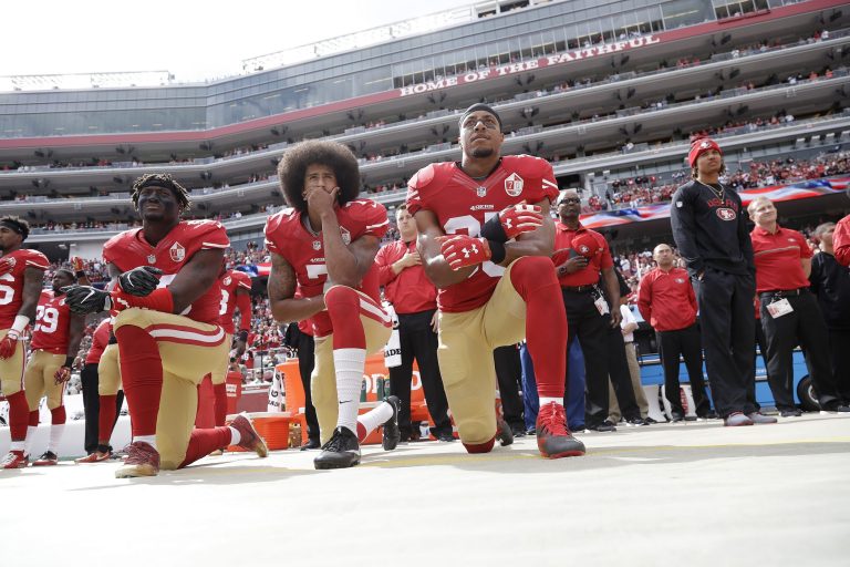 San Francisco 49ers outside linebacker Eli Harold, left, quarterback Colin Kaepernick, center, and safety Eric Reid kneel during the national anthem before an NFL football game against the Dallas Cowboys in Santa Clara, Calif., Sunday, Oct. 2, 2016. (AP Photo/Marcio Jose Sanchez)