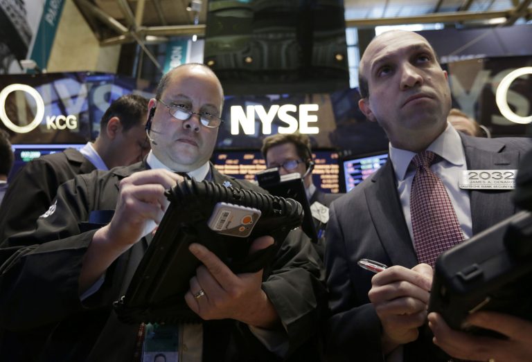 In this Wednesday, March 12, 2014, photo, traders Jeffrey Vazquez, left, and James Denaro work on the floor of the New York Stock Exchange.  Most global stock markets fell sharply Friday March 14, 2014 over persistent concerns about weakness in the Chinese economy and tensions in Ukraine.  (AP Photo/Richard Drew)