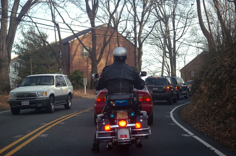 In this file photo a Fairfax County Police Department Motorcycle Officer works his way up a hill slowly on Chain Bridge Rd. during the beginning of rush hour. 2006/John Shinkle/ Examiner