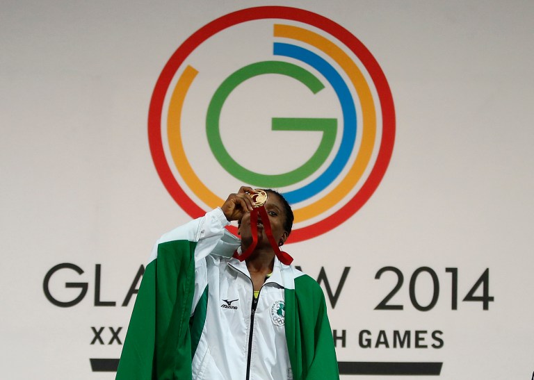 FILE - This is a Friday, July, 25, 2014 file photo  of Chika Amalaha of Nigeria, as he kisses her gold medal for winning the women's 53 kg weightlifting competition at the Commonwealth Games Glasgow 2014, in Glasgow, Scotlanddid. The Nigerian weightlifting gold medalist Chika Amalaha has failed a doping test at the Commonwealth Games and has been provisionally suspended from the games. Commonwealth Games Federation chief executive Mike Hooper said Tuesday July 29, 2014 that Amalaha tested positive for diuretics and masking agents after being tested on July 25.  (AP Photo/Alastair Grant, File)