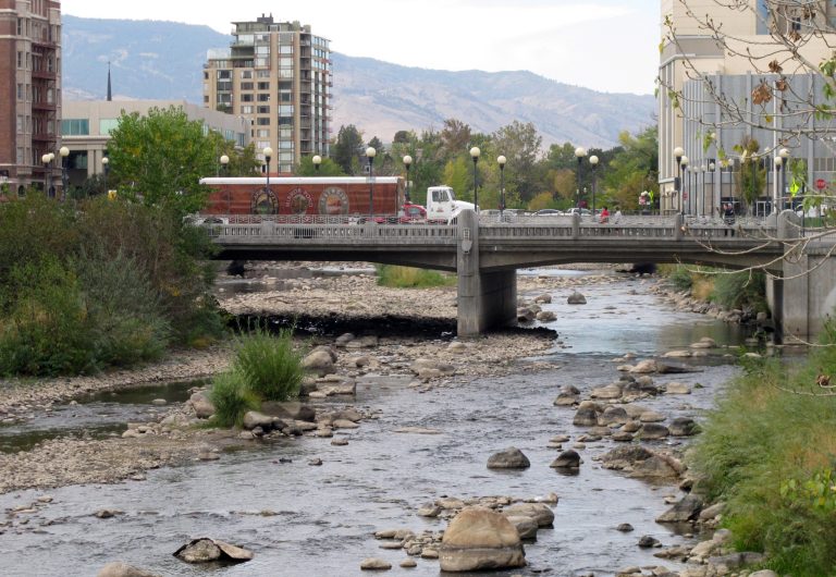 Traffic crosses the Center Street bridge in downtown Reno, Nev., on Friday, Oct. 17, 2014, over the Truckee River, which has been reduced to a shallow stream. Lake Tahoe dropped below its natural rim level for the first time in five years this week, which cut off flows into the river as it meanders 30 miles down the Sierra and through Reno on a 90-mile journey to Pyramid Lake. (AP Photo/Scott Sonner)