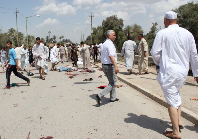Iraqis gather at the scene of a bomb attack in Baqouba, northeast of Baghdad, Iraq, Friday, May 17, 2013. A bomb killed dozens of people at a Sunni mosque in central Iraq, hitting worshippers as they were emerging from Friday prayers, security officials said. The attack in Baqouba comes after two days of attacks, many in Shiite districts, left tens of people dead. Attacks against Sunni mosques have also been on the rise recently, raising fears that the country is slipping into a new round of sectarian violence. (AP Photo/Adem Hadei)