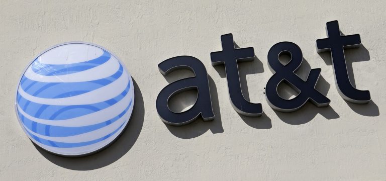 FILE - This Wednesday, Feb. 8, 2017, file photo shows the AT&T sign at a store in Hialeah, Fla. AT&Ts $85 billion purchase of Time Warner may be getting an easier path to approval after the chief telecommunications regulator says it isnt likely to review the deal. (AP Photo/Alan Diaz, File)