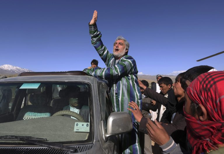 FILE - In this Tuesday, June 10, 2014 file photo, Afghan presidential candidate Abdullah Abdullah greets supporters at an election campaign rally in Ghor province, Afghanistan.  The planned release of preliminary results from the runoff vote in Afghanistan's presidential election will probably be postponed, a spokesman said Tuesday, a move that comes as officials struggle to resolve an impasse over fraud allegations. Abdullah Abdullah, one of the two candidates vying to replace President Hamid Karzai, has warned he would boycott the results as he claims that supporters of his rival Ashraf Ghani Ahmadzai engineered fraud in the June 14 balloting. (AP Photo/Omar Sobhani, Pool, File)