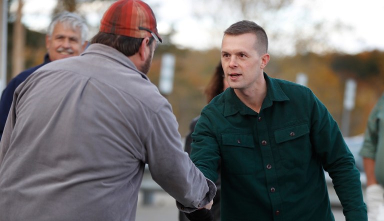 Jared Golden, the Democratic candidate for the 2nd District congressional seat in Maine, greets a worker at the Verso paper mill while campaigning, Thursday, Oct. 25, 2018, in Jay, Maine.