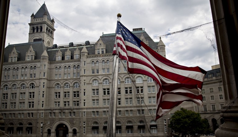 The Trump International Hotel stands past an American flag flying outside the Environmental Protection Agency headquarters in Washington, D.C., on July 11, 2018.
