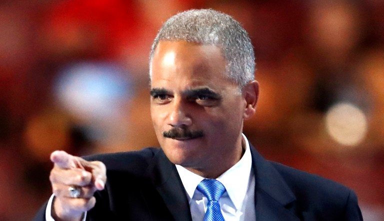 Former Attorney General Eric Holder takes the stage during an event.