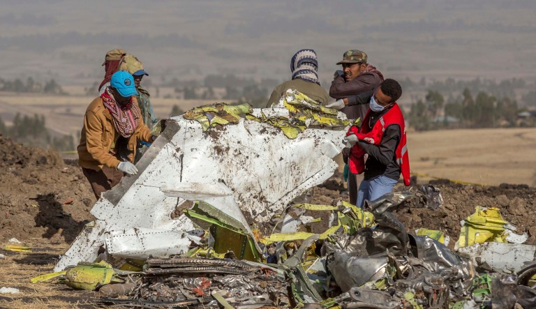Rescuers work at the scene of an Ethiopian Airlines flight crash near Bishoftu, or Debre Zeit, south of Addis Ababa,  Ethiopia, Monday, March 11, 2019.