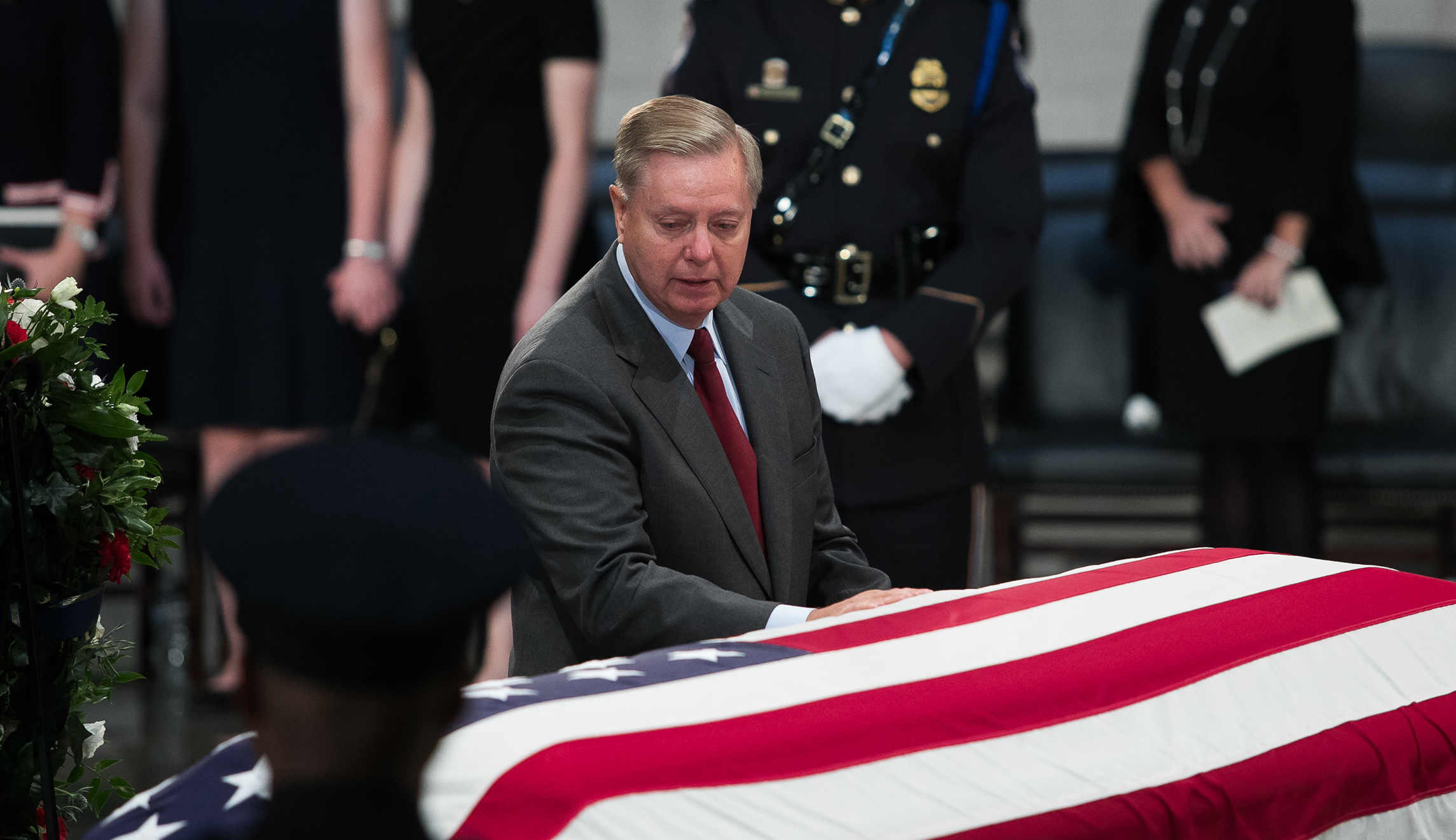Sen. Lindsey Graham, R-S.C., stands in front of the flag-draped casket of Sen. John McCain at the Capitol in D.C.