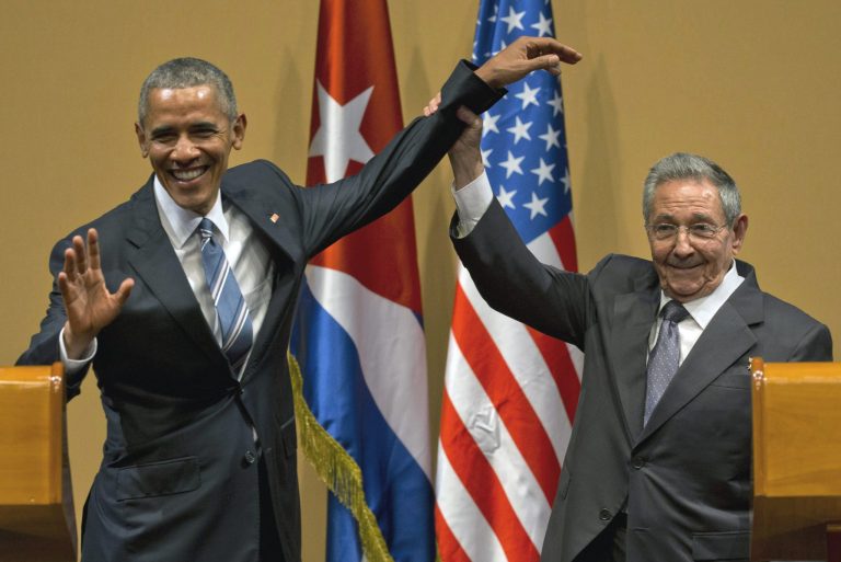 Cuban President Raul Castro, right, lifts up the arm of President Barack Obama at the conclusion of their joint news conference at the Palace of the Revolution, Monday, March 21, 2016, in Havana, Cuba. (AP Photo/Ramon Espinosa)