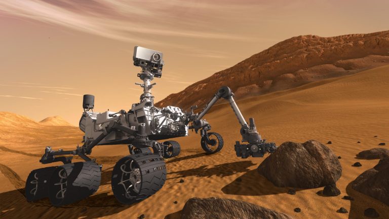   FILE - In this 2011 artist's rendering provided by NASA/JPL-Caltech, the Mars Science Laboratory Curiosity rover examines a rock on Mars with a set of tools at the end of its arm, which extends about 2 meters (7 feet). The mobile robot is designed to investigate Mars' past or present ability to sustain microbial life. Curiosity is set to land in a crater near the Martian equator in August 2012 to begin a two-year mission. (AP Photo/NASA/JPL-Caltech,File)  