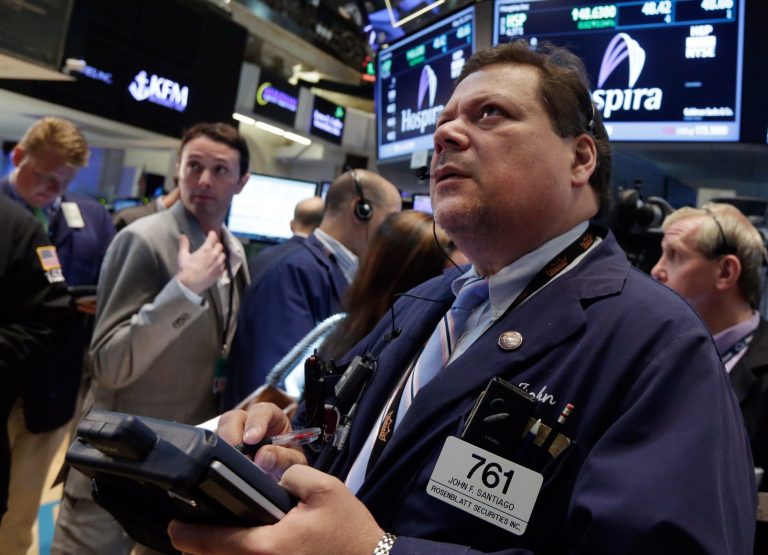 Trader John Santiago, right, works on the floor of the New York Stock Exchange Friday, May 30, 2014. Two negative reports on U.S. consumers were pushing stocks lower in early trading Friday. (AP Photo/Richard Drew)