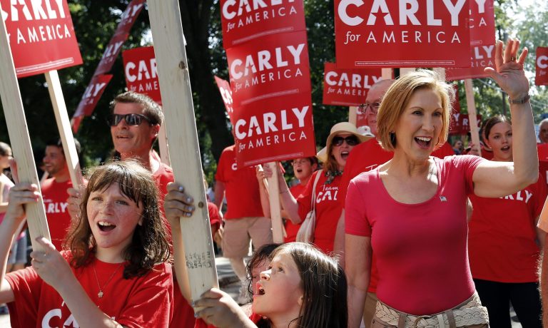 Republican presidential candidate Carly Fiorina, the former Hewlett-Packard chief executive waves as she and supporters march in the Labor Day parade Monday, Sept. 7, 2015, in Milford, N.H. (AP Photo/Jim Cole)