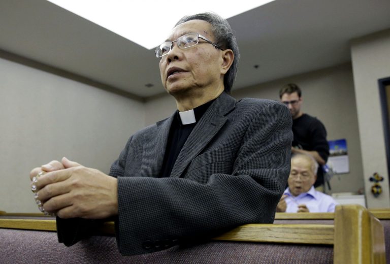 Father Jim Khoi prays the rosary at the Our Lady of Fatima Church where the family of nurse Nina Pham attend, Monday, Oct. 13, 2014, in Fort Worth, Texas. Pham, 26, became the first person to contract Ebola within the United States. (AP Photo/LM Otero)