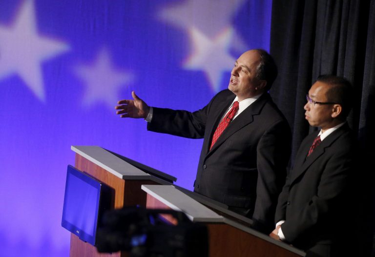 Rhode Island Republican gubernatorial candidate businessman Ken Block, left, responds to a question as fellow Republican candidate for governor Allan Fung, mayor of Cranston, looks on during a primary debate, Wednesday, Sept. 3, 2014, in Providence. (AP Photo/Steven Senne)