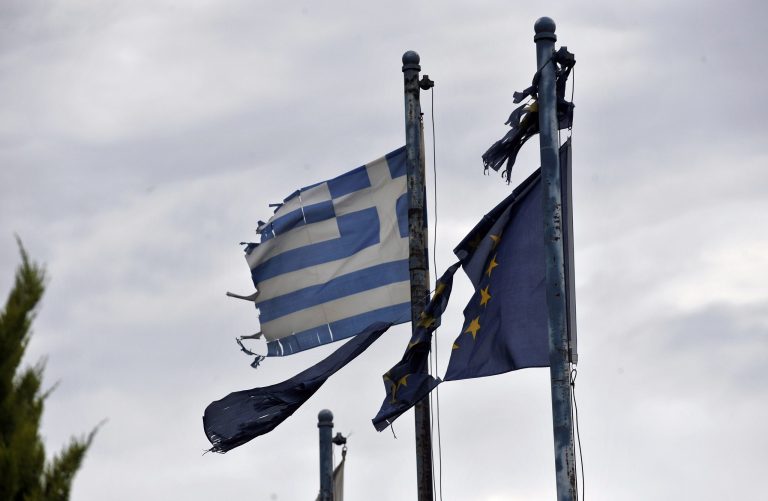   In this Friday, May 25, 2012 photo torn EU and Greek flags fly at the entrance of an abandoned factory in the industrial zone of Komotini about 800 kilometers (500 miles) northeast of Athens. In its heyday just over a decade ago, the industrial zone in this far-flung area of northern Greece was a hive of activity, with dozens of factories producing everything from textiles to ceramics and employing nearly 20,000 people. Now, the Komotini industrial zone is a picture of desolation, a stark illustration of the toll Greece's vicious financial crisis has taken on the country's industry. (AP Photo/Nikolas Giakoumidis)  