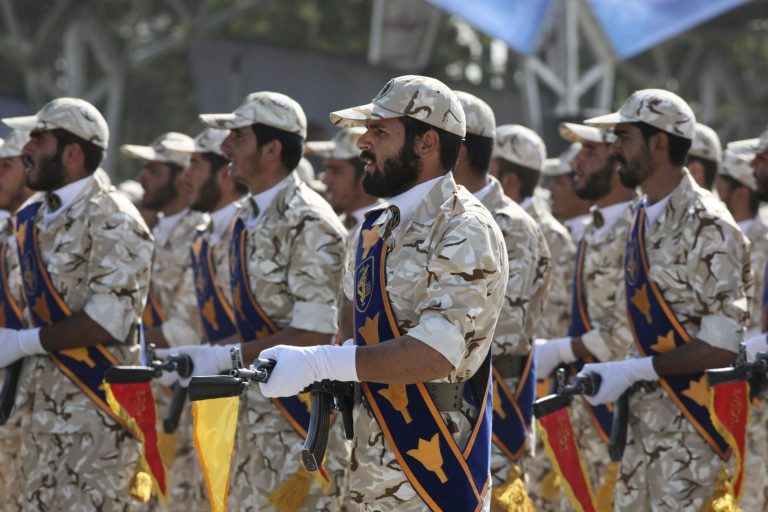 In this Sept. 22, 2011 photo, members of Iran's Revolutionary Guard march in front of the mausoleum of the late Iranian revolutionary founder Ayatollah Khomeini, just outside Tehran, Iran, during armed an forces parade marking the 31st anniversary of the start of the Iraq-Iran war. According to a report,Â Iran is providing arms, financing, training and travel to foreign fighters helping the Assad regime in Syria, including Afghans.Â Much of the activity is funneled through the Iranian Revolutionary Guard Corps and its Quds Force, which are the targets of much of the U.S. sanctions against Iran.Â (AP Photo/Vahid Salemi)