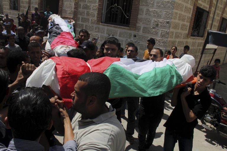 Palestinian relatives carry national flag-draped bodies of Omar al-Bareem, 17, and his brother Mohammed, 12, who were killed in an Israeli strike on a car, during their funeral at their family house in Khan Younis, in the southern Gaza Strip, Wednesday, Aug. 27, 2014. Two brother were killed in an airstrike on a car yesterday east of Khan Younis, according to Gaza health official Ashraf al-Kidra. (AP Photo/Hatem Ali)