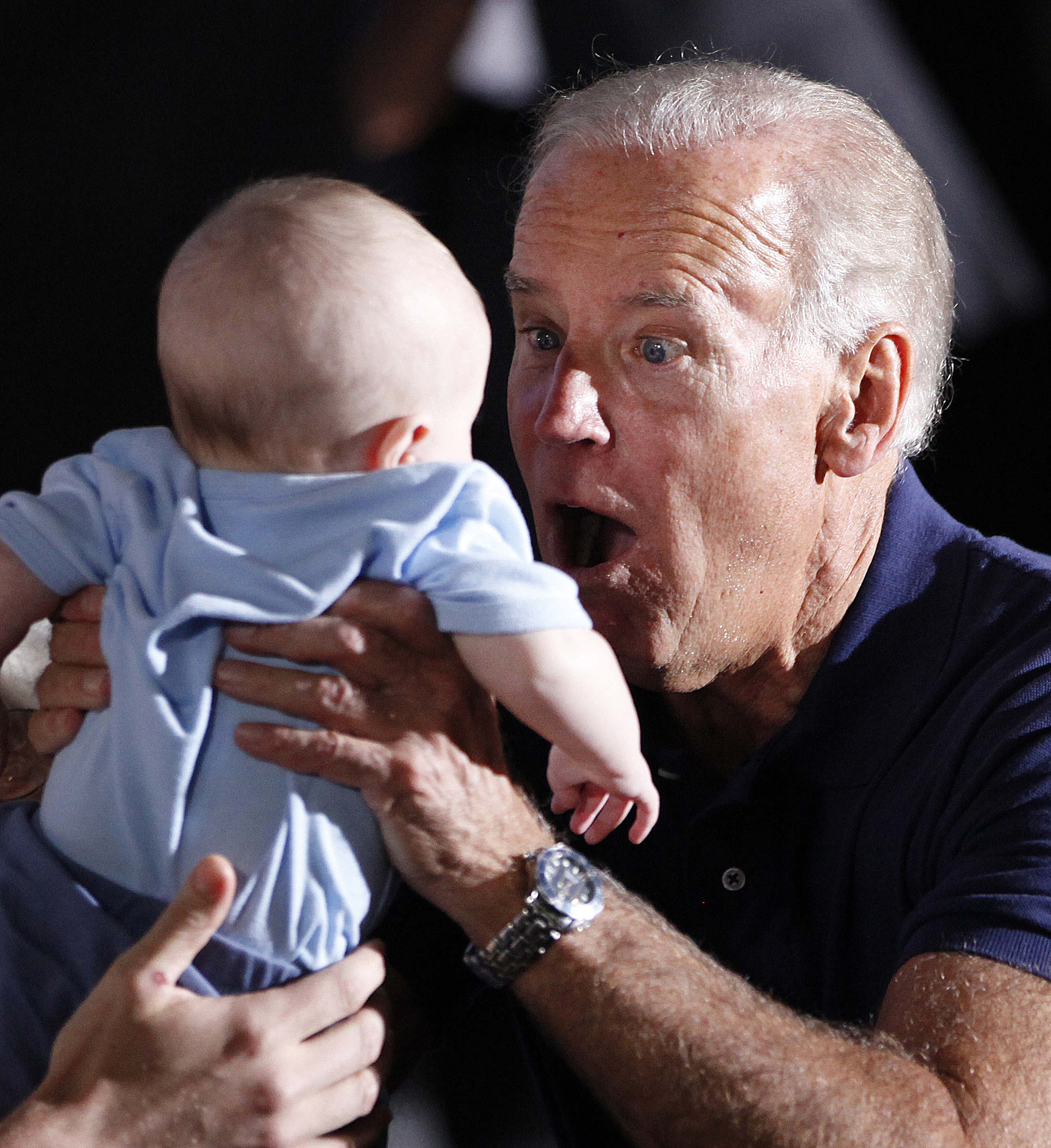 Photo: Biden tries desperately to entertain a baby