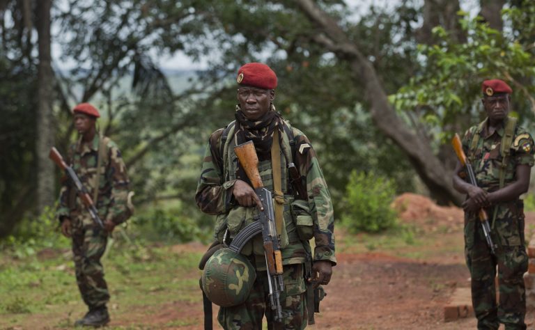 FILE - In this Sunday, April 29, 2012 file photo, troops from the Central African Republic stand guard at a building used for joint meetings between them and U.S. Army special forces, in Obo, Central African Republic, where U.S. special forces have paired up with local troops and Ugandan soldiers to seek out Joseph Kony's Lord's Resistance Army (LRA). African troops captured a junior commander with the LRA - a rebel lieutenant known as Charles Okello - and rescued 10 people, mostly children, abducted by the rebels, Uganda's military said Tuesday, April 22, 2014, the latest blow against the rebel group in an international hunt for its fugitive leaders. (AP Photo/Ben Curtis, File)